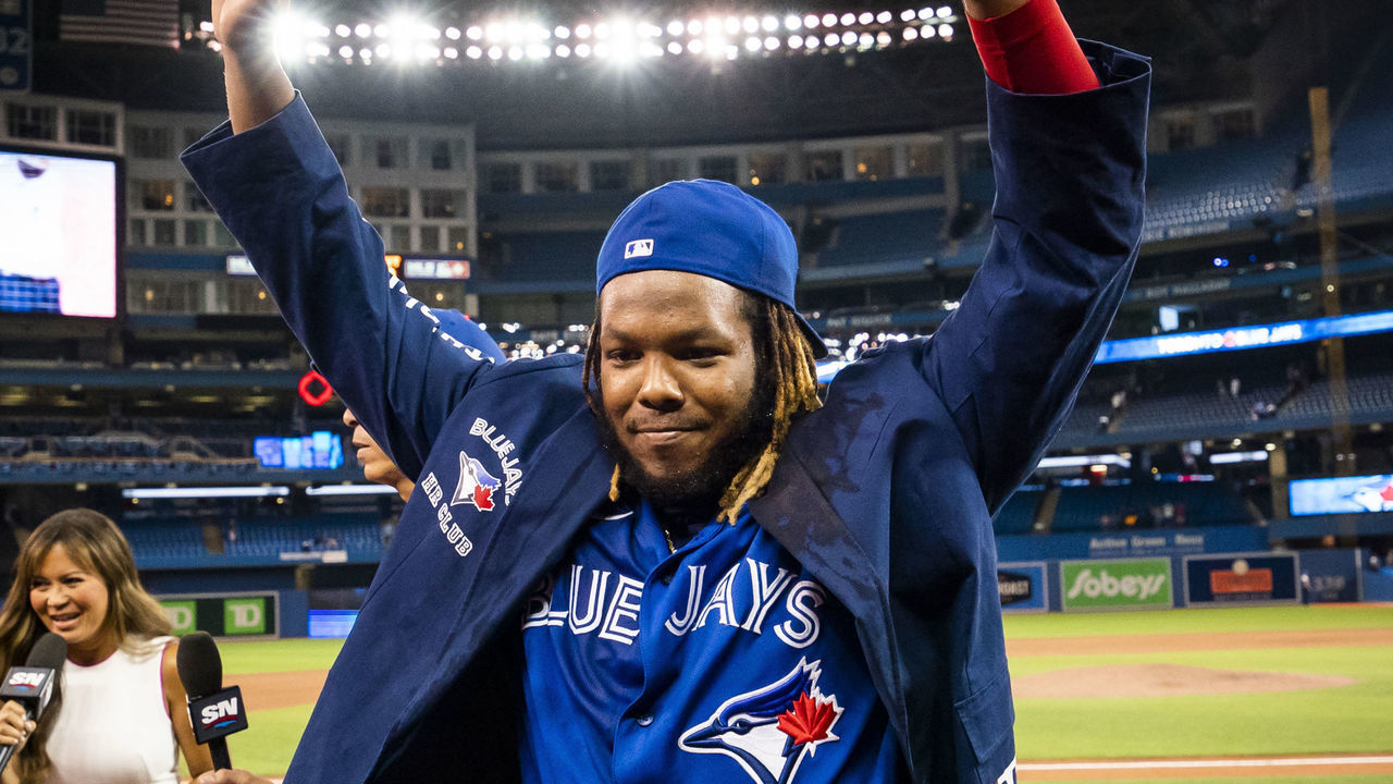 TORONTO, ONTARIO - AUGUST 30: Vladimir Guerrero Jr. #27 of the Toronto Blue Jays celebrates with "u201cThe Blue Jacket"u201d after hitting two home runs in a game after his team defeated the Baltimore Orioles in their MLB game at the Rogers Centre on August 30, 2021 in Toronto, Ontario, Canada.