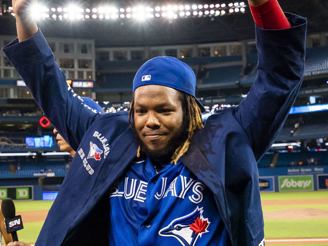 TORONTO, ONTARIO - AUGUST 30: Vladimir Guerrero Jr. #27 of the Toronto Blue Jays celebrates with "u201cThe Blue Jacket"u201d after hitting two home runs in a game after his team defeated the Baltimore Orioles in their MLB game at the Rogers Centre on August 30, 2021 in Toronto, Ontario, Canada.