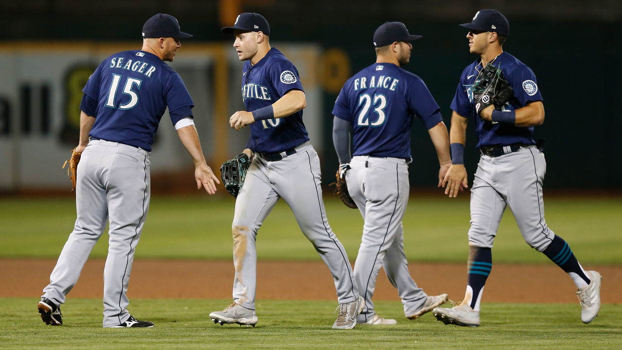 OAKLAND, CALIFORNIA - SEPTEMBER 22: Kyle Seager #15, Jarred Kelenic #10, Ty France #23 and Dylan Moore #25 of the Seattle Mariners celebrate after a win against the Oakland Athletics at RingCentral Coliseum on September 22, 2021 in Oakland, California.