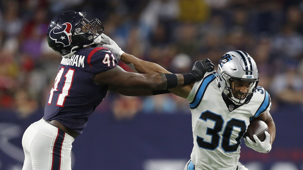HOUSTON, TEXAS - SEPTEMBER 23: Chuba Hubbard #30 of the Carolina Panthers tries to hold off the tackle of Zach Cunningham #41 of the Houston Texans during a first half run at NRG Stadium on September 23, 2021 in Houston, Texas.