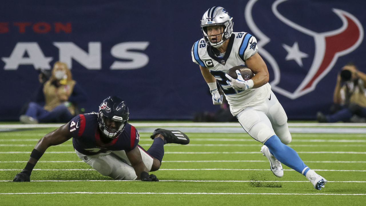 HOUSTON, TX - SEPTEMBER 23: Carolina Panthers running back Christian McCaffrey (22) evades a tackle by Houston Texans inside linebacker Zach Cunningham (41) in the first quarter during the football game between the Carolina Panthers and Houston Texans on September 23, 2021 at NRG Stadium in Houston, Texas.