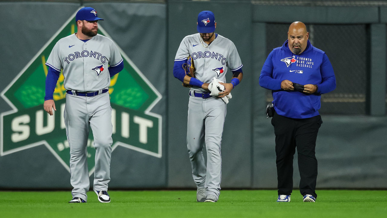 MINNEAPOLIS, MN - SEPTEMBER 23: Lourdes Gurriel Jr. #13, center, walks to the dugout with a medical trainer and John Schneider #21 of the Toronto Blue Jays after getting injured in the fifth inning of the game against the Minnesota Twins. Gurriel Jr. did not return to the game at Target Field on September 23, 2021 in Minneapolis, Minnesota. The Twins defeated the Blue Jays 7-2.