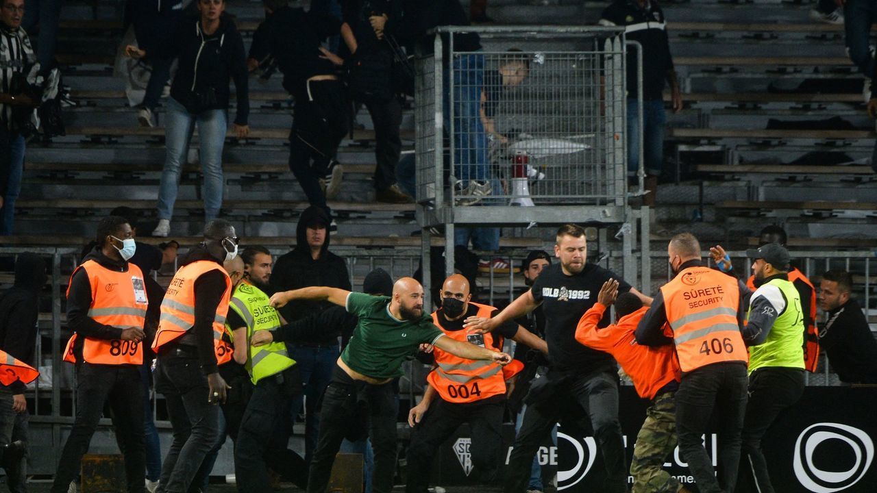 Marseille's supporters invade the field after the French L1 football match between Angers (ASCO) and Marseille (OM), at Raymond-Kopa stadium in Angers, on September 22, 2021.