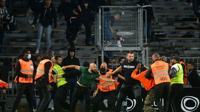 Marseille's supporters invade the field after the French L1 football match between Angers (ASCO) and Marseille (OM), at Raymond-Kopa stadium in Angers, on September 22, 2021.
