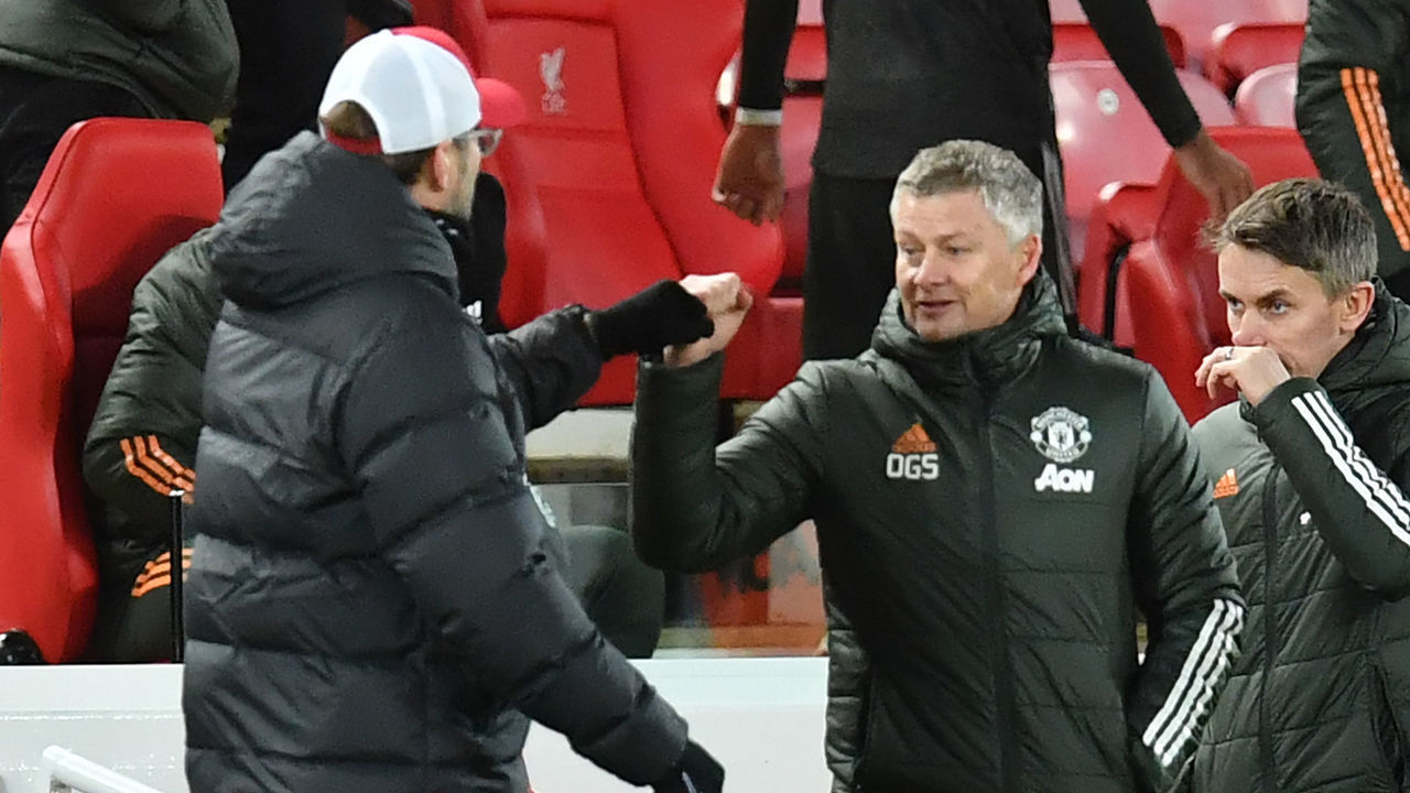 Manchester United's Norwegian manager Ole Gunnar Solskjaer (R) gestures to Liverpool's German manager Jurgen Klopp (L) after the English Premier League football match between Liverpool and Manchester United at Anfield in Liverpool, north west England on January 17, 2021. - The game finished 0-0.