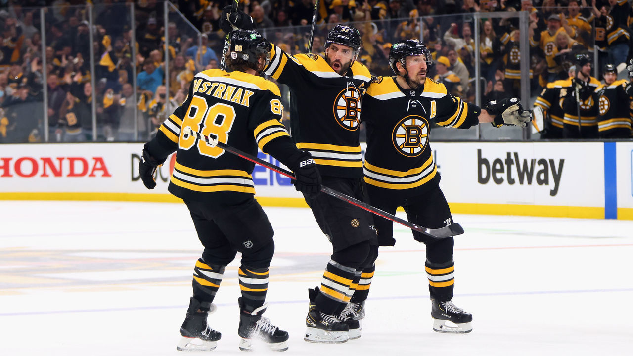 BOSTON, MASSACHUSETTS - MAY 31: (L-R) David Pastrnak #88, Patrice Bergeron #37 and Brad Marchand #63 of the Boston Bruins celebrate Bergeron's goal at 10:34 of the third period against the New York Islanders in Game Two of the Second Round of the 2021 Stanley Cup Playoffs at the TD Garden on May 31, 2021 in Boston, Massachusetts.