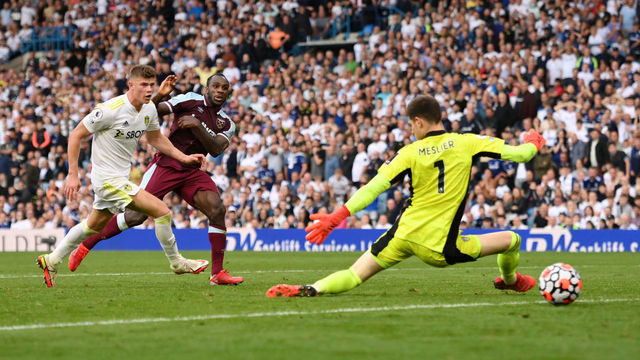 LEEDS, ENGLAND - SEPTEMBER 25: Michail Antonio of West Ham United scores their side's second goal past Illan Meslier of Leeds United during the Premier League match between Leeds United and West Ham United at Elland Road on September 25, 2021 in Leeds, England.