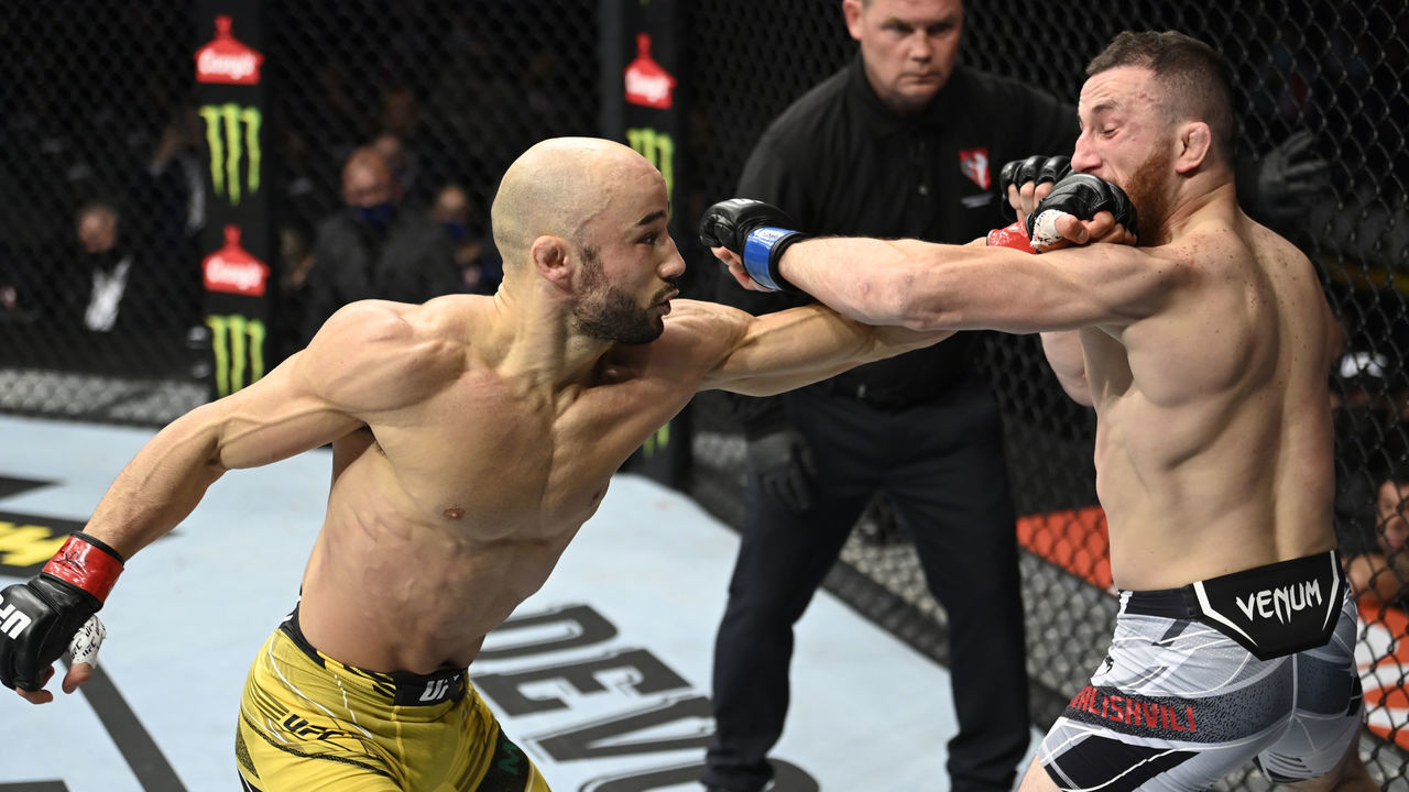 LAS VEGAS, NEVADA - SEPTEMBER 25: (L-R) Marlon Moraes of Brazil punches Merab Dvalishvili of Georgia in their bantamweight fight during the UFC 266 event on September 25, 2021 in Las Vegas, Nevada.
