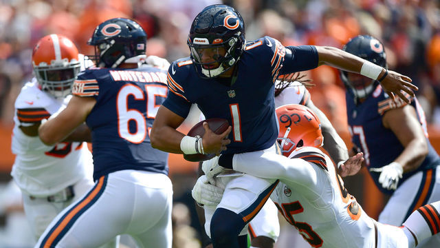 CLEVELAND, OHIO - SEPTEMBER 26: Justin Fields #1 of the Chicago Bears tries to avoid a sack by Myles Garrett #95 of the Cleveland Browns during the first half at FirstEnergy Stadium on September 26, 2021 in Cleveland, Ohio.