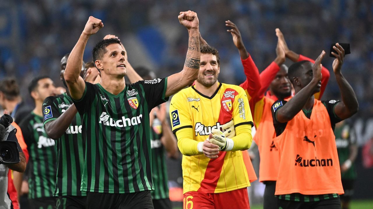Lens' French forward Florian Sotoca (L) and teammates celebrate their victory at the end of the French L1 football match between Olympique Marseille (OM) and RC Lens at Stade Velodrome in Marseille, southern France on September 26, 2021.