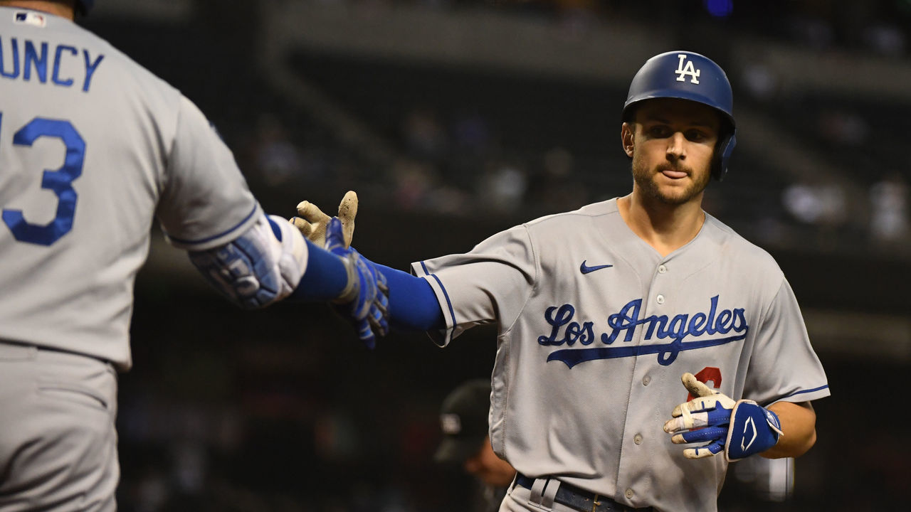 PHOENIX, ARIZONA - SEPTEMBER 25: Trea Turner #6 of the Los Angeles Dodgers celebrates with Max Muncy #13 after hitting a solo home run off of Zac Gallen #23 of the Arizona Diamondbacks during the sixth inning at Chase Field on September 25, 2021 in Phoenix, Arizona.