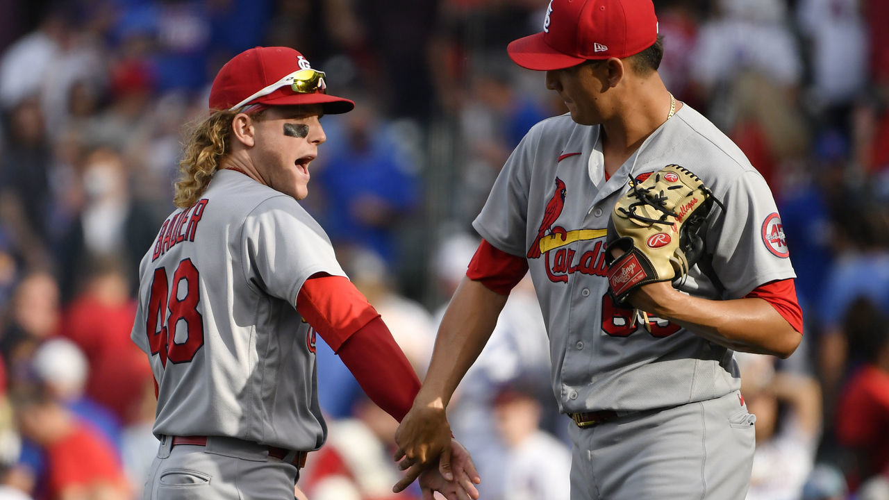 CHICAGO, ILLINOIS - SEPTEMBER 26: Harrison Bader #48 of the St. Louis Cardinals and Giovanny Gallegos #65 of the St. Louis Cardinals celebrate the team win against the Chicago Cubs at Wrigley Field on September 26, 2021 in Chicago, Illinois.
