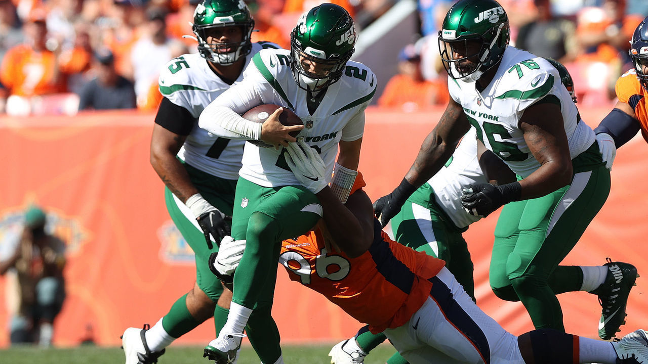 DENVER, COLORADO - SEPTEMBER 26: Quarterback Zach Wilson #2 of the New York Jets is tackled by Shelby Harris #96 of the Denver Broncos in the first half of the game at Empower Field At Mile High on September 26, 2021 in Denver, Colorado.