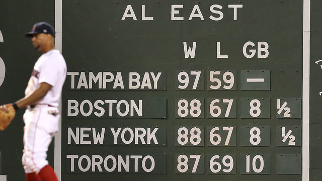 Boston, MA - September 26: The AL East standings loom behind Boston Red Sox shortstop Xander Bogaerts (2) in the 9th inning. The Boston Red Sox hosted the New York Yankees in a regular season MLB game at Fenway Park in Boston on September 26, 2021.