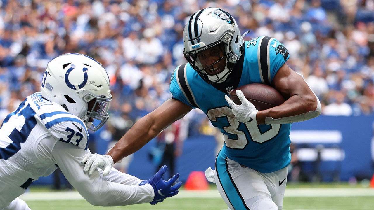 INDIANAPOLIS, INDIANA - AUGUST 15: Chuba Hubbard #30 of the Carolina Panthers avoids a tackle from Ibraheim Campbell #33 of the Indianapolis Colts during the second quarter of the preseason game at Lucas Oil Stadium on August 15, 2021 in Indianapolis, Indiana.
