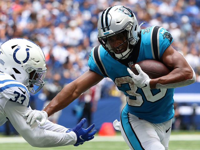 INDIANAPOLIS, INDIANA - AUGUST 15: Chuba Hubbard #30 of the Carolina Panthers avoids a tackle from Ibraheim Campbell #33 of the Indianapolis Colts during the second quarter of the preseason game at Lucas Oil Stadium on August 15, 2021 in Indianapolis, Indiana.