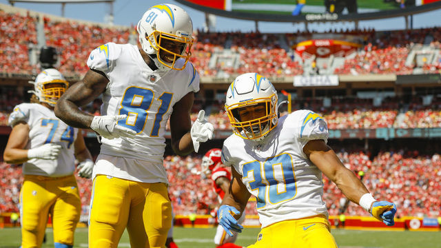 KANSAS CITY, MO - SEPTEMBER 26: Austin Ekeler #30 of the Los Angeles Chargers celebrates his second quarter touchdown with Mike Williams #81 of the Los Angeles Chargers against the Kansas City Chiefs at Arrowhead Stadium on September 26, 2021 in Kansas City, Missouri.