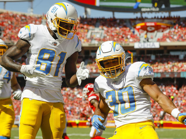 KANSAS CITY, MO - SEPTEMBER 26: Austin Ekeler #30 of the Los Angeles Chargers celebrates his second quarter touchdown with Mike Williams #81 of the Los Angeles Chargers against the Kansas City Chiefs at Arrowhead Stadium on September 26, 2021 in Kansas City, Missouri.