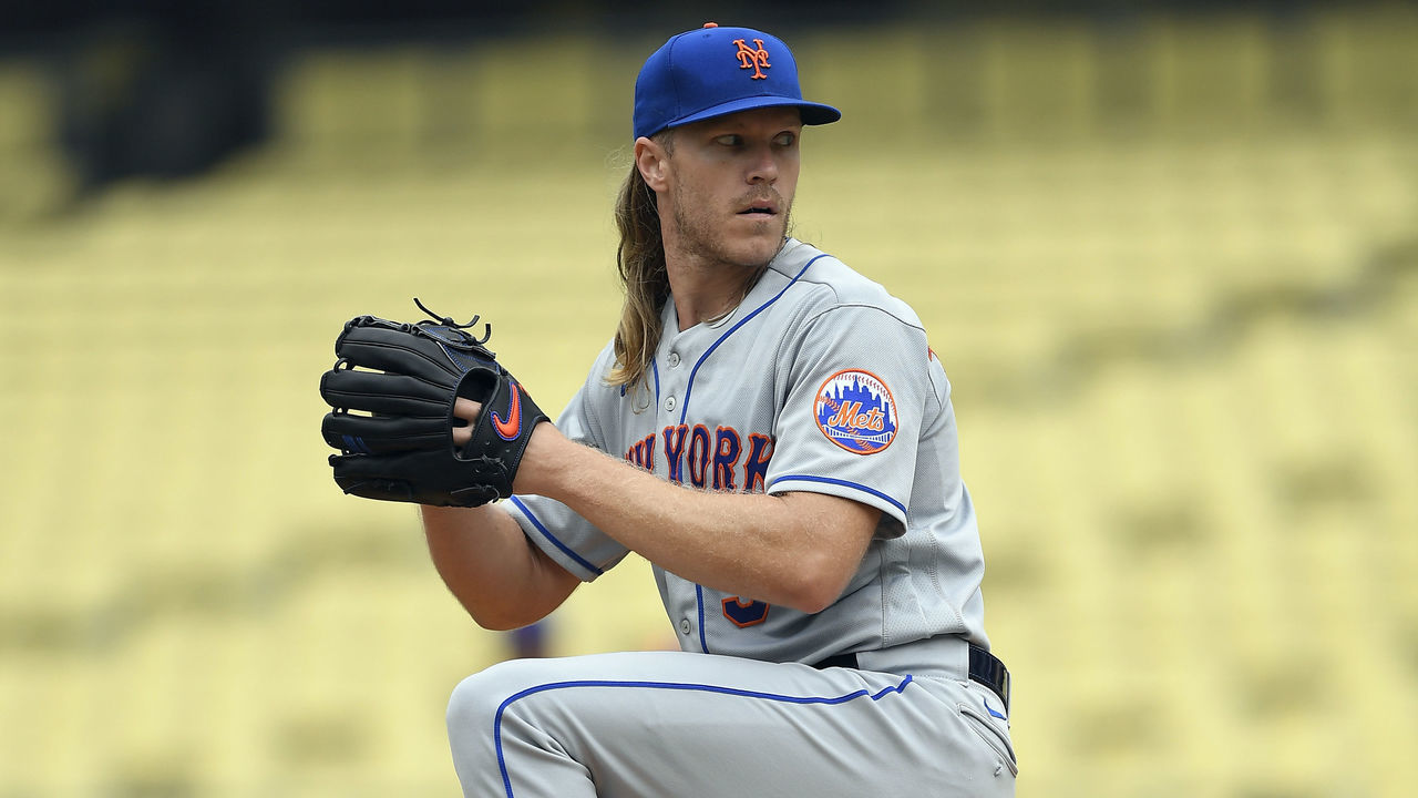 LOS ANGELES, CA - AUGUST 21: Pitcher Noah Syndergaard #34 of the New York Mets throws off the mound during warm-up in front of trainers and coaches before the start of the game against Los Angeles Dodgers at Dodger Stadium on August 21, 2021 in Los Angeles, California.
