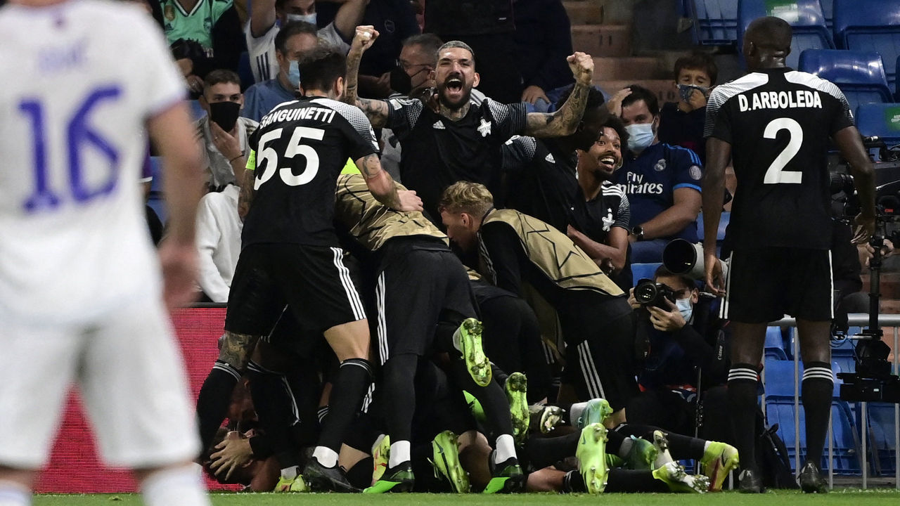 Sheriff's players celebrate their second goal during the UEFA Champions League first round group D footbal match between Real Madrid and Sheriff Tiraspol at the Santiago Bernabeu stadium in Madrid, on September 28, 2021.