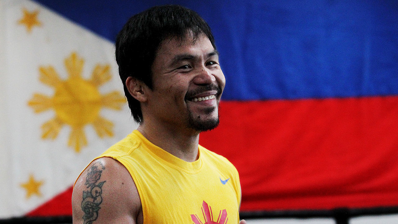 LOS ANGELES, CA - MARCH 9: Filipino prizefighter Manny Pacquiao is framed by a flag of the Philippines as he opens training camp at the Wild Card Boxing Gym on March 9, 2015 in Los Angeles, California. Pacquiao is in preparation for a much anticipated match against Floyd Mayweather in about two months.