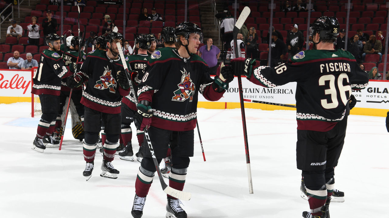 GLENDALE, ARIZONA - SEPTEMBER 27: Ryan Dzingel #10 of the Arizona Coyotes celebrates with Christian Fischer #36 after a 2-1 win against the Los Angeles Kings at Gila River Arena on September 27, 2021 in Glendale, Arizona.