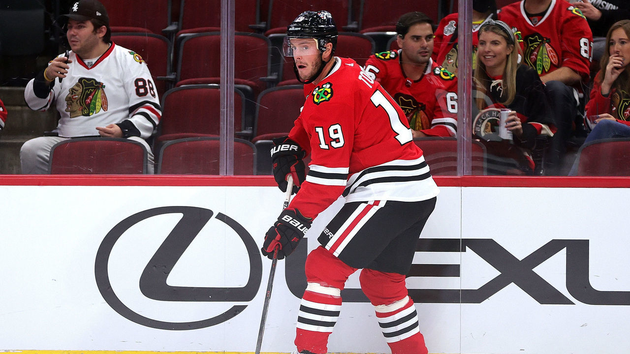 CHICAGO, ILLINOIS - SEPTEMBER 29: Jonathan Toews #19 of the Chicago Blackhawks controls the puck during the first period of a preseason game against the Detroit Red Wings at the United Center on September 29, 2021 in Chicago, Illinois.