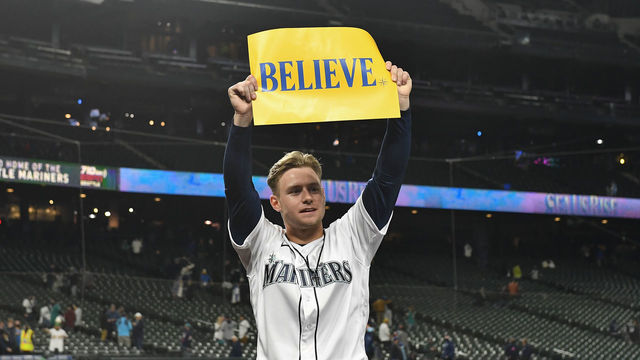 SEATTLE, WASHINGTON - SEPTEMBER 29: Jarred Kelenic #10 of the Seattle Mariners holds up a "Believe" sign after the game against the Oakland Athletics at T-Mobile Park on September 29, 2021 in Seattle, Washington. The Mariners won 4-2.
