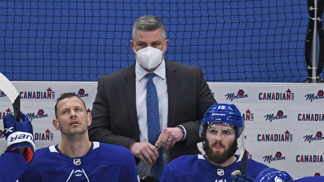 TORONTO, ON - MAY 06: Toronto Maple Leafs Head Coach Sheldon Keefe behind the bench during the regular season NHL game between the Montreal Canadiens and Toronto Maple Leafs on May 6, 2021 at Scotiabank Arena in Toronto, ON.