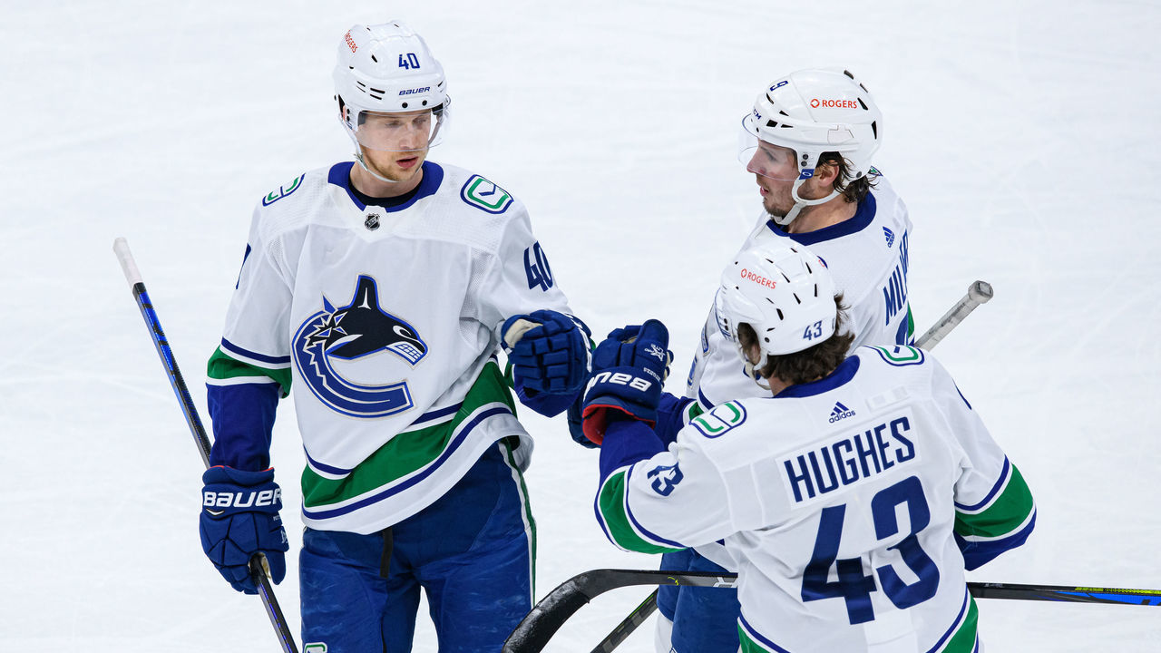 TORONTO, ON - FEBRUARY 08: Vancouver Canucks Center Elias Pettersson (40) celebrates his goal with Defenceman Quinn Hughes (43) and Left Wing J.T. Miller (9) during the second period of the NHL regular season game between the Vancouver Canucks and the Toronto Maple Leafs on February 8, 2021, at Scotiabank Arena in Toronto, ON, Canada.