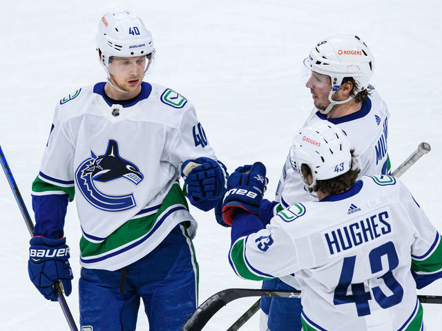 TORONTO, ON - FEBRUARY 08: Vancouver Canucks Center Elias Pettersson (40) celebrates his goal with Defenceman Quinn Hughes (43) and Left Wing J.T. Miller (9) during the second period of the NHL regular season game between the Vancouver Canucks and the Toronto Maple Leafs on February 8, 2021, at Scotiabank Arena in Toronto, ON, Canada.