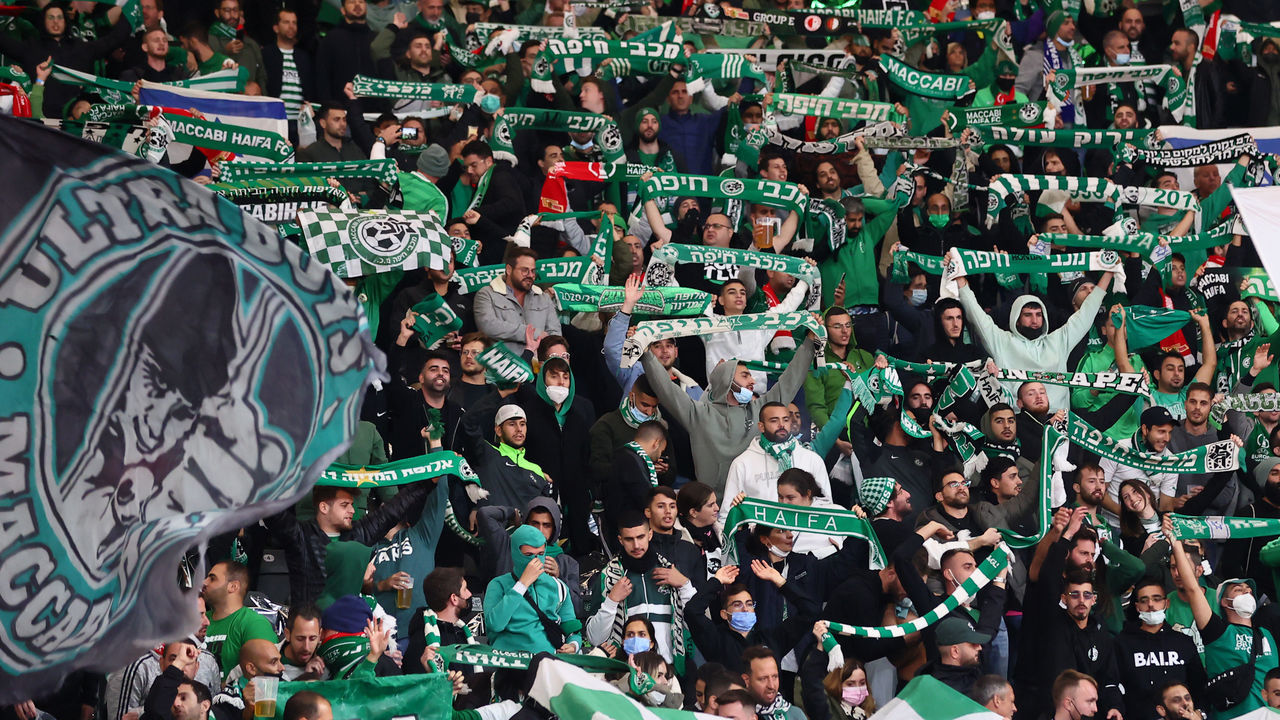 BERLIN, GERMANY - SEPTEMBER 30: Maccabi Haifa fans show their support by waving flags inside the stduring the UEFA Europa Conference League group E match between 1. FC Union Berlin and Maccabi Haifa at on September 30, 2021 in Berlin, Germany.