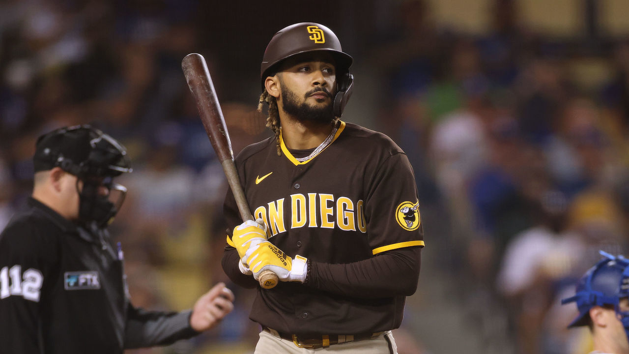 LOS ANGELES, CALIFORNIA - SEPTEMBER 30: Fernando Tatis Jr. #23 of the San Diego Padres reacts to his strikeout in front of Will Smith #16 of the Los Angeles Dodgers and umpire Jeremy Riggs #112 during the seventh inning at Dodger Stadium on September 30, 2021 in Los Angeles, California.
