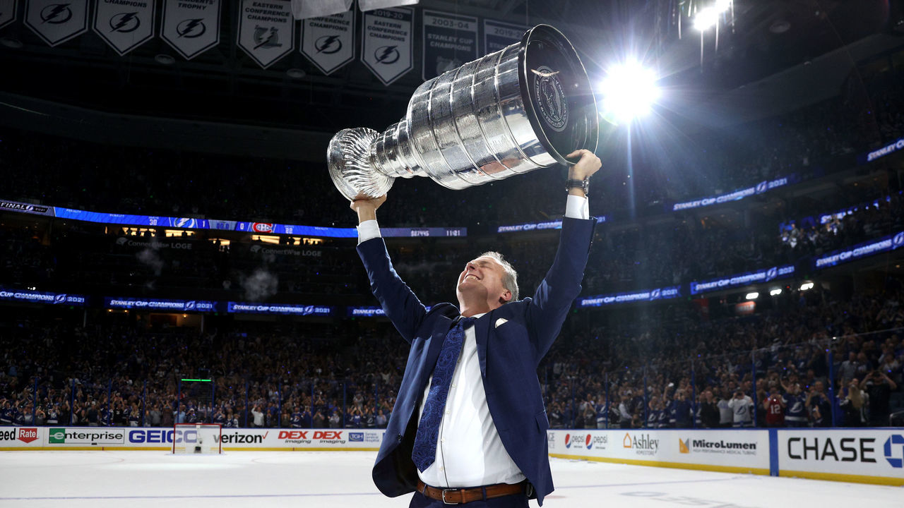 TAMPA, FLORIDA - JULY 07: Head coach Jon Cooper of the Tampa Bay Lightning hoists the Stanley Cup after their 1-0 victory in Game Five of the 2021 Stanley Cup Final to win the series four games to one against the Montreal Canadiens at Amalie Arena on July 07, 2021 in Tampa, Florida.