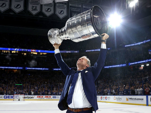 TAMPA, FLORIDA - JULY 07: Head coach Jon Cooper of the Tampa Bay Lightning hoists the Stanley Cup after their 1-0 victory in Game Five of the 2021 Stanley Cup Final to win the series four games to one against the Montreal Canadiens at Amalie Arena on July 07, 2021 in Tampa, Florida.