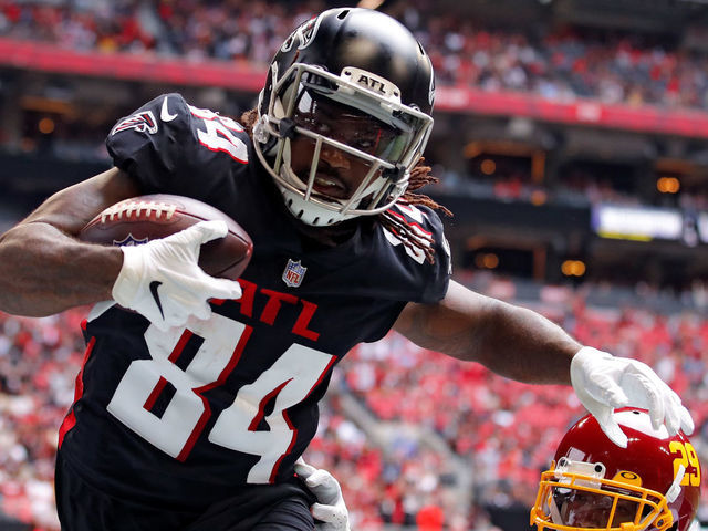 ATLANTA, GEORGIA - OCTOBER 03: Cordarrelle Patterson #84 of the Atlanta Falcons scores a touchdown reception against Kendall Fuller #29 of the Washington Football Team in the third quarter at Mercedes-Benz Stadium on October 03, 2021 in Atlanta, Georgia.