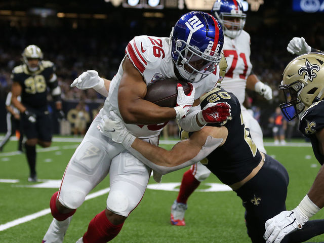 NEW ORLEANS, LOUISIANA - OCTOBER 03: Saquon Barkley #26 of the New York Giants is tackled by Pete Werner #20 of the New Orleans Saints during the first quarter at Caesars Superdome on October 03, 2021 in New Orleans, Louisiana.