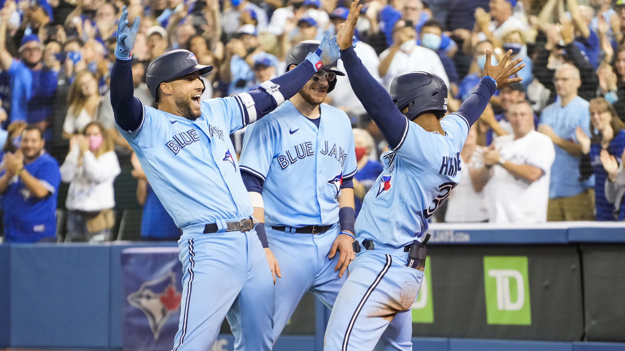 TORONTO, ONTARIO - OCTOBER 3: George Springer #4 of the Toronto Blue Jays celebrates his grand slam with Teoscar Hernandez #37 and Danny Jansen #9 in the third inning during their MLB game against the Baltimore Orioles at the Rogers Centre on October 3, 2021 in Toronto, Ontario, Canada.