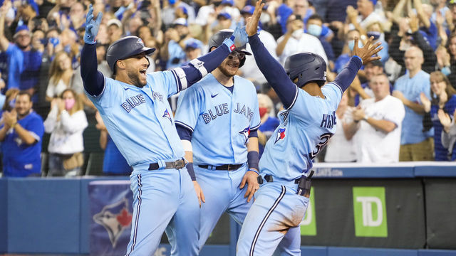 TORONTO, ONTARIO - OCTOBER 3: George Springer #4 of the Toronto Blue Jays celebrates his grand slam with Teoscar Hernandez #37 and Danny Jansen #9 in the third inning during their MLB game against the Baltimore Orioles at the Rogers Centre on October 3, 2021 in Toronto, Ontario, Canada.