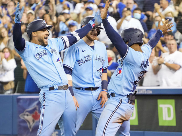 TORONTO, ONTARIO - OCTOBER 3: George Springer #4 of the Toronto Blue Jays celebrates his grand slam with Teoscar Hernandez #37 and Danny Jansen #9 in the third inning during their MLB game against the Baltimore Orioles at the Rogers Centre on October 3, 2021 in Toronto, Ontario, Canada.