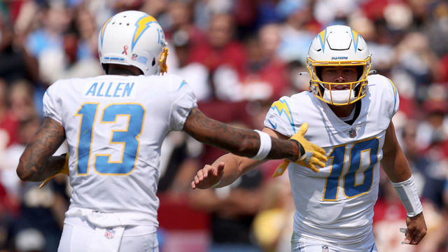 LANDOVER, MARYLAND - SEPTEMBER 12: Justin Herbert #10 and Keenan Allen #13 celebrate against the Washington Football Team during the first half at FedExField on September 12, 2021 in Landover, Maryland.