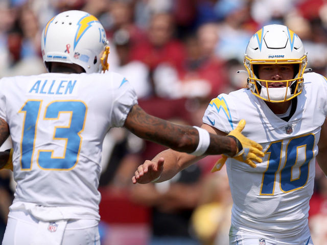 LANDOVER, MARYLAND - SEPTEMBER 12: Justin Herbert #10 and Keenan Allen #13 celebrate against the Washington Football Team during the first half at FedExField on September 12, 2021 in Landover, Maryland.