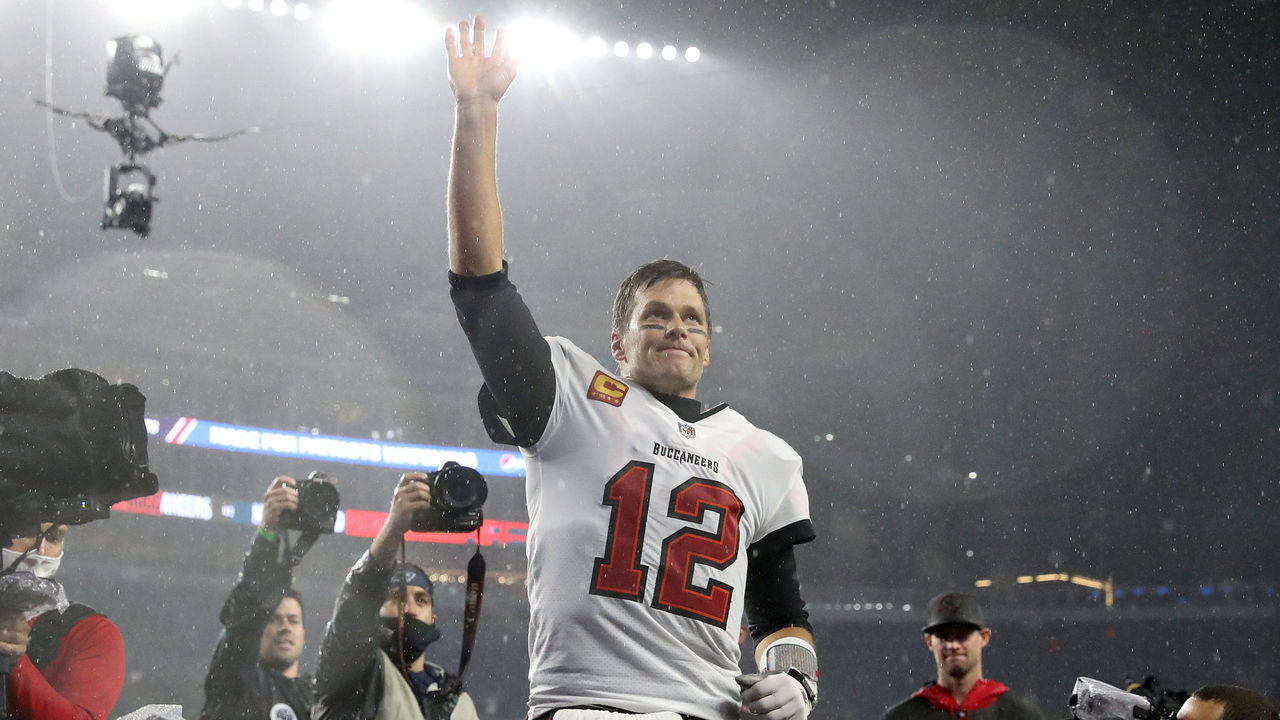 FOXBOROUGH, MASSACHUSETTS - OCTOBER 03: Tom Brady #12 of the Tampa Bay Buccaneers waves to the crowd as he runs off the field after defeating the New England Patriots in the game at Gillette Stadium on October 03, 2021 in Foxborough, Massachusetts.