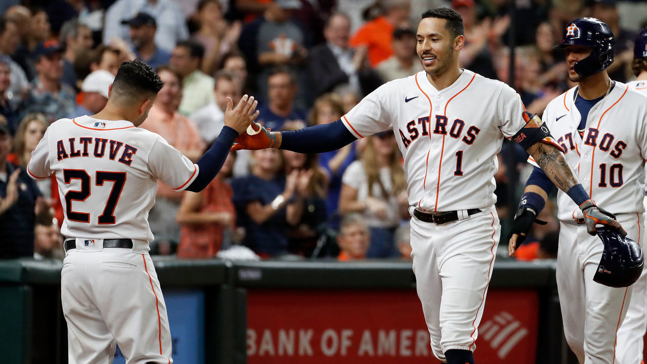 HOUSTON, TEXAS - SEPTEMBER 30: Carlos Correa #1 of the Houston Astros is congratulated by Jose Altuve #27 after a three run home run in the fourth inning against the Tampa Bay Rays at Minute Maid Park on September 30, 2021 in Houston, Texas.
