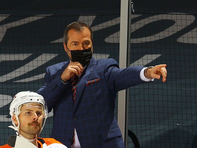 UNIONDALE, NEW YORK - MARCH 18: Alain Vigneault of the Philadelphia Flyers looks on from the bench during the game against the New York Islanders at Nassau Coliseum on March 18, 2021 in Uniondale, New York. Philadelphia Flyers defeated the New York Islanders 4-3.