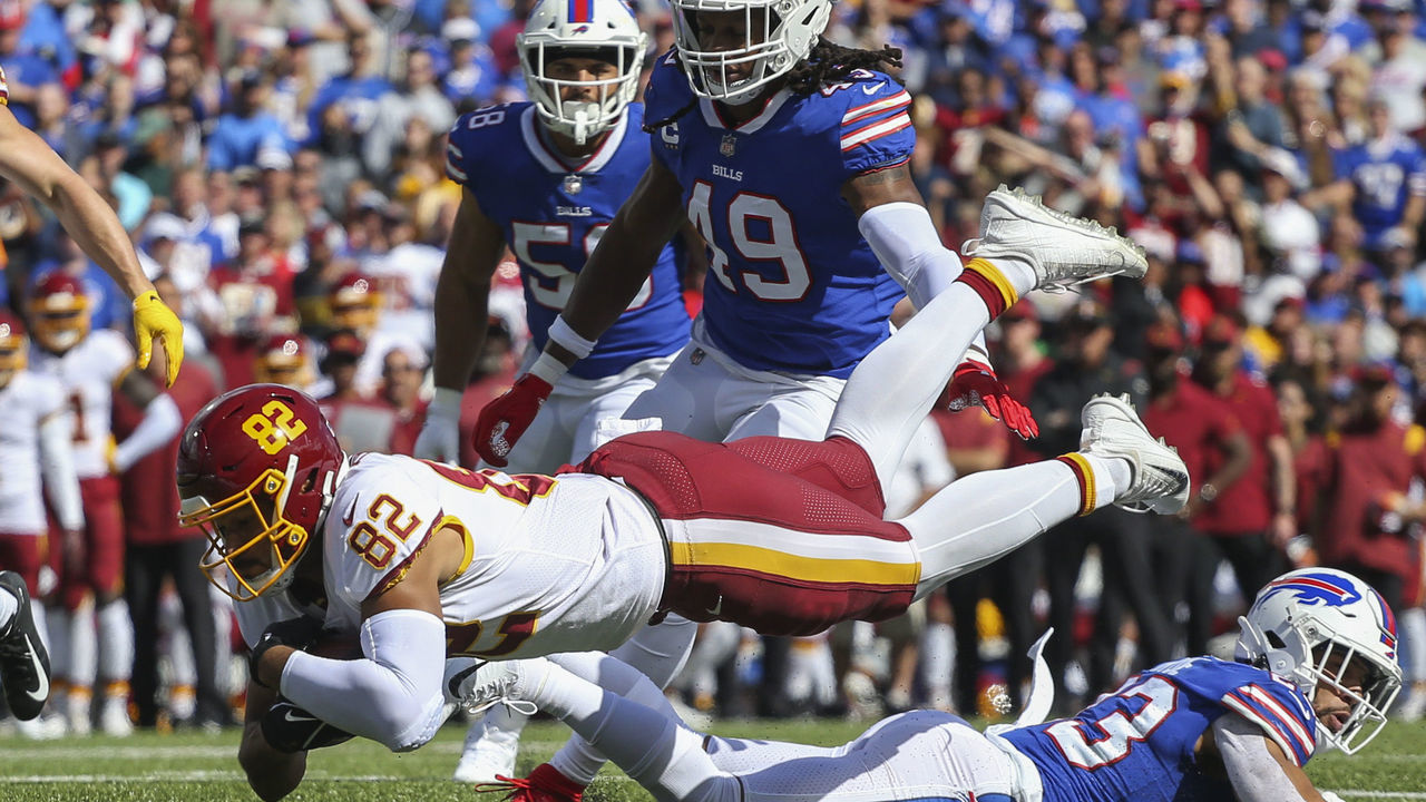 ORCHARD PARK, NEW YORK - SEPTEMBER 26: Logan Thomas #82 of the Washington Football Team lunges forward for an extra yard as he's tackled during the second quarter of the game against the Buffalo Bills at Highmark Stadium on September 26, 2021 in Orchard Park, New York.