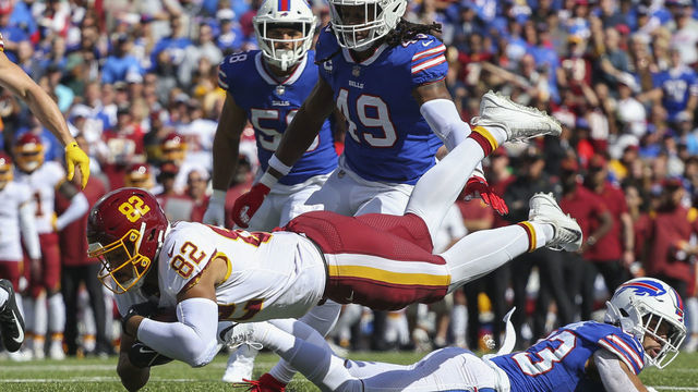 ORCHARD PARK, NEW YORK - SEPTEMBER 26: Logan Thomas #82 of the Washington Football Team lunges forward for an extra yard as he's tackled during the second quarter of the game against the Buffalo Bills at Highmark Stadium on September 26, 2021 in Orchard Park, New York.