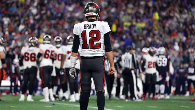 FOXBOROUGH, MASSACHUSETTS - OCTOBER 03: Tom Brady #12 of the Tampa Bay Buccaneers walks towards the huddle during the game against the New England Patriots at Gillette Stadium on October 03, 2021 in Foxborough, Massachusetts.