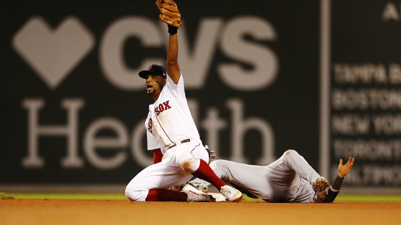 BOSTON, MASSACHUSETTS - SEPTEMBER 26: Xander Bogaerts #2 of the Boston Red Sox reacts after tagging out Tyler Wade #14 of the New York Yankees in the top of the eighth inning at Fenway Park on September 26, 2021 in Boston, Massachusetts.