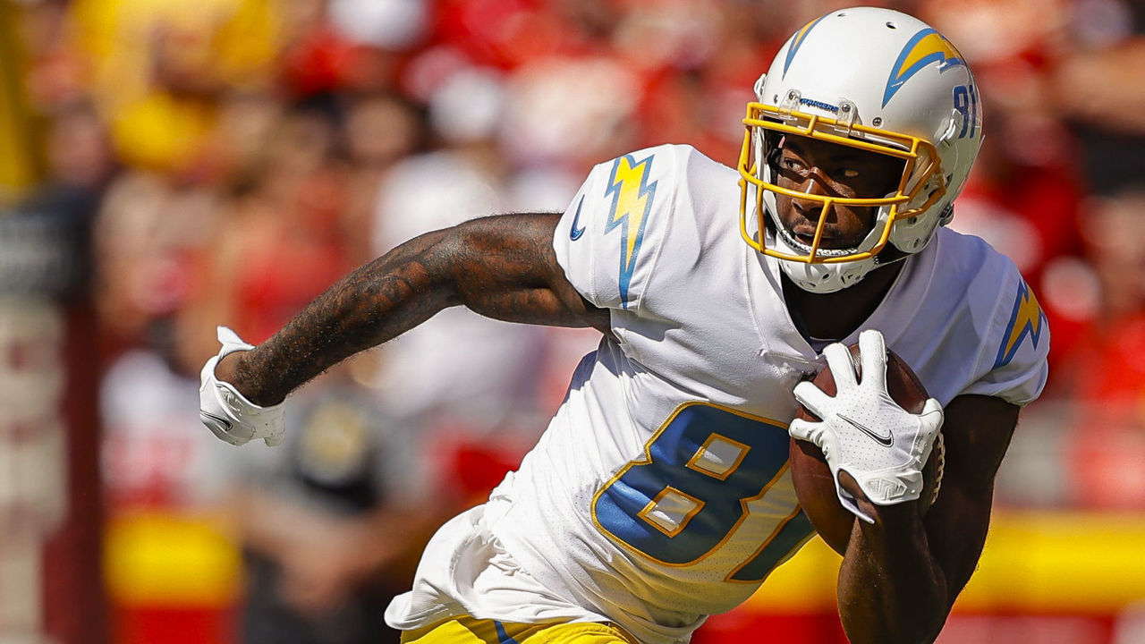 KANSAS CITY, MO - SEPTEMBER 26: Mike Williams #81 of the Los Angeles Chargers breaks free from the tackle attempt from L'Jarius Sneed #38 of the Kansas City Chiefs at Arrowhead Stadium on September 26, 2021 in Kansas City, Missouri.